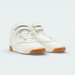 Angled shot of both Reebok Freestyle Hi trainers side by side, showcasing the high-top silhouette and the vintage 1982-inspired design.