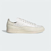 Adidas Stan Smith Recon Men's trainers in core white leather, side profile showing clean lines, perforated 3-Stripes, and classic silhouette.