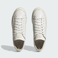 Top-down view of a pair of Adidas Stan Smith Recon Men's trainers in white, highlighting their sleek silhouette, flat laces, and premium leather upper.