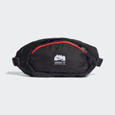 Adidas Adventure Waist Bag in black with bright red and white accents, front view showing main zip pocket, front zip pocket, and woven Adidas brand patch.