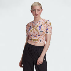 Woman wearing the Adidas x Her Studio London Cropped Tee with a multi-color floral print, demonstrating its stylish fit and cropped length.