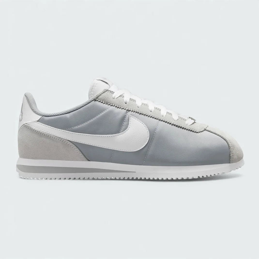 Gray sneaker with a white Nike logo on a light gray background