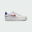 Nike Air Force 1 LV8 Juniors' trainers in white with royal blue and red accents, side profile showing classic leather upper, perforated toe box, and Nike Swoosh.