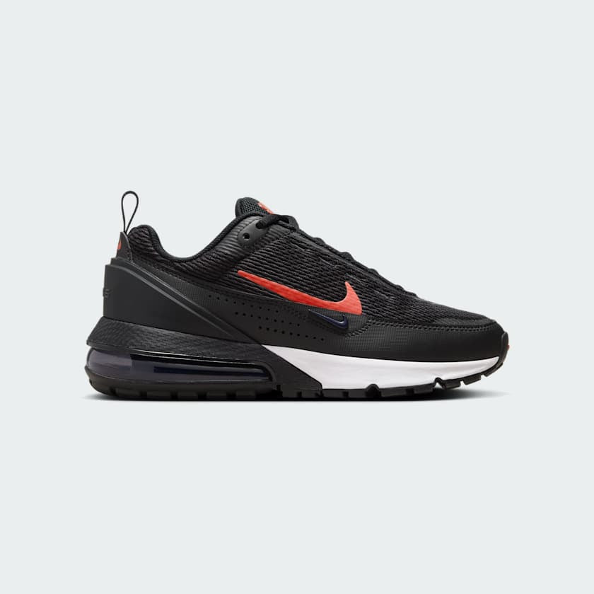 Nike Air Max Pulse Juniors' trainers in black with university red accents, side profile showing visible point-loaded Max Air unit and layered textile upper.