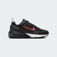 Nike Air Max Pulse Juniors' trainers in black with university red accents, side profile showing visible point-loaded Max Air unit and layered textile upper.