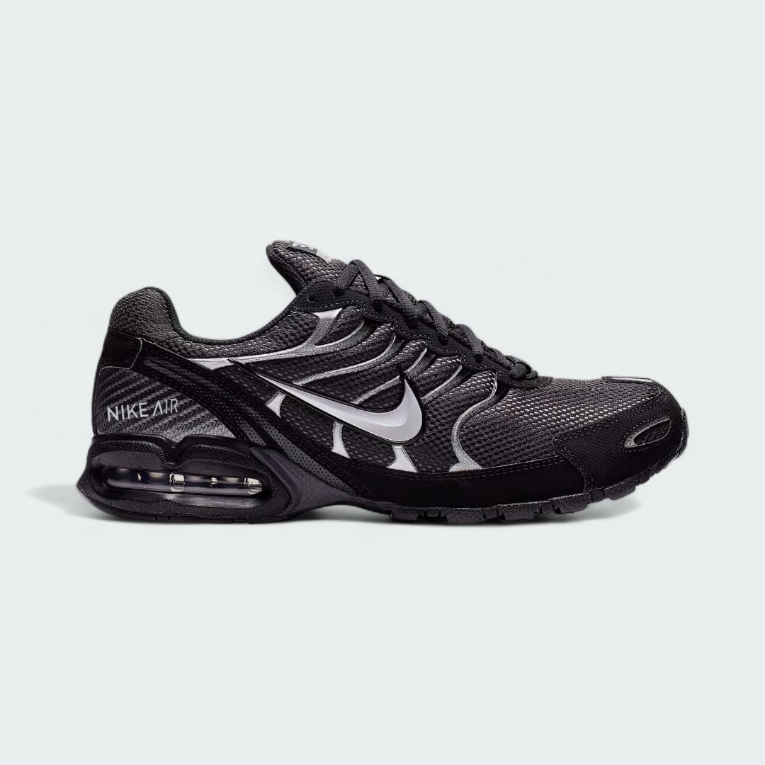 Nike Air Max Torch Men's running trainer in black, side profile showing mesh upper, visible Max Air unit in the heel, and a prominent Nike Swoosh