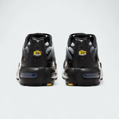 Rear view of the Nike Air Max Plus TN Juniors' trainers, focusing on the prominent Tuned Air branding on the heel and wavy design elements.