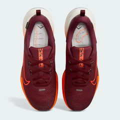 Top-down view of a pair of Nike Juniper Trail 2 GORE-TEX V2 trail shoes in red and orange, highlighting their durable construction and lace-up closure.