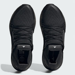 Top-down view of a pair of Adidas by Stella McCartney Ultra Boost 20 Women's trainers in black, highlighting their seamless Primeknit construction and unique lacing.