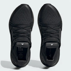 Top-down view of a pair of Adidas by Stella McCartney Ultra Boost 20 Women's trainers in black, highlighting their seamless Primeknit construction and unique lacing.