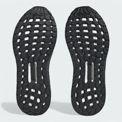 View of the outsole of the Adidas by Stella McCartney Ultra Boost 20 trainers, showing the durable rubber sole and Boost cushioning visible through the grid pattern.