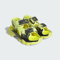 Angled view of two Adidas by Stella McCartney Hika Sandals in yellow and black, side by side, showcasing their robust yet stylish design.