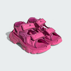 Angled view of two Adidas by Stella McCartney Hika Sandals in pink, side by side, showcasing their robust yet stylish design.