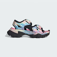 Adidas by Stella McCartney Hika Sandal in pink, yellow, and black, side profile showing adjustable hook-and-loop straps, chunky sole, and collaborative branding