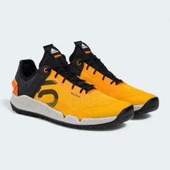 Angled view of two Adidas Five Ten Trailcross LT shoes in solar gold and black, side by side, showcasing their hybrid trail design.