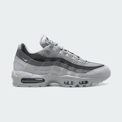 Nike Air Max 95 Men's running shoes in shades of grey, side profile showing visible Max Air units in the heel and forefoot, and a layered upper.