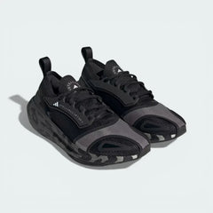 Three-quarter view of the pair, showcasing the contrast between the core black knit and the crisp cloud white midsole.