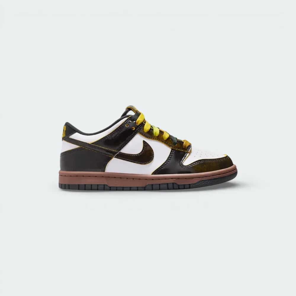 Side profile of the Nike Dunk Low Kids SE, showing the classic black and white Panda color-blocking with a vibrant Bright Citron yellow Swoosh.