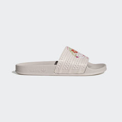 Adidas Adilette Slides Unisex in pink with a white strap, side profile showing the classic single-strap design and contoured footbed.