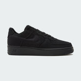 Nike Air Force 1 Low Canvas Men's trainers in black, side profile showing canvas upper, classic Swoosh, and white midsole.