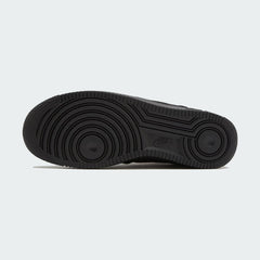 View of the outsole of the Nike Air Force 1 Low Canvas Men's black trainers, showing the durable rubber sole and pivot circles for traction.