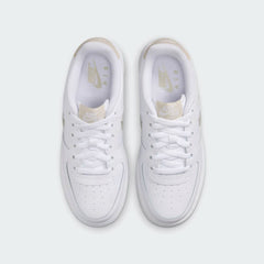 Top-down view of a pair of Nike Air Force 1 Low Juniors' trainers in white and sand, highlighting the lace-up closure and iconic silhouette.