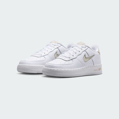 Angled view of two Nike Air Force 1 Low Juniors' trainers in white and sand, side by side, showcasing their timeless design and clean aesthetic.