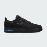 Nike Air Force 1 '07 Men's trainers in black leather with a blue Nike Swoosh, side profile showing classic silhouette, perforated toe box, and cushioned sole.