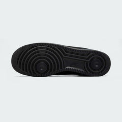 View of the outsole of the Nike Air Force 1 '07 Men's black trainers, showing the durable rubber sole and pivot circles for traction.