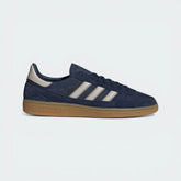 The Collegiate Navy Spezial, highlighting the two-tone Bliss 3-Stripes and the gleaming Gold Metallic wordmark.