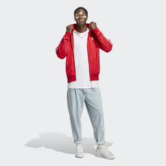 Model wearing the red adidas Firebird jacket