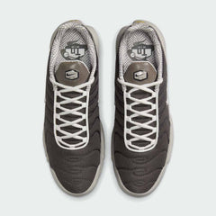 Top-down view of a pair of Nike Air Max Plus TN Men's trainers in brown and grey, highlighting their iconic silhouette and lace-up closure.