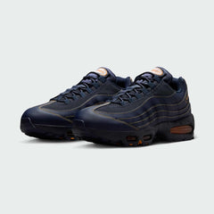 Angled view of two Nike Air Max 95 OG Men's running shoes in obsidian blue, side by side, showcasing their timeless design and layered upper.