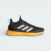 Side profile of the adidas Adizero Ubersonic 4.1 Clay in Aurora Black, showing the Zero Metallic three stripes and the vibrant Spark neon accents on the midsole.
