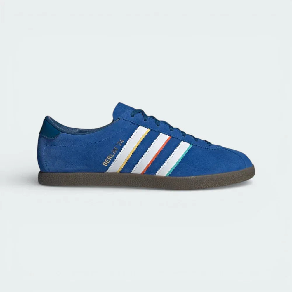 Side profile of the blue suede adidas Berlin 24, showing the color-tipped 3-Stripes and the gold "Berlin 24" branding.