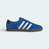 Side profile of the blue suede adidas Berlin 24, showing the color-tipped 3-Stripes and the gold "Berlin 24" branding.