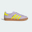 Side Profile Image: The Silver Dawn nubuck Gazelle, highlighting the electric Solar Yellow 3-Stripes and the translucent gum rubber sole.