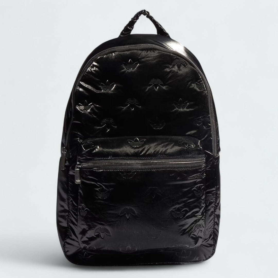 Adidas Puffy Satin Backpack in black, front view showing its sleek, padded silhouette, main zipper, and front zip pocket.