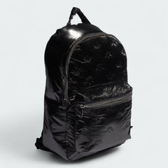 Side profile of the Adidas Puffy Satin Backpack in black, highlighting its puffy design and depth.