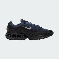 Nike Air Max DN Men's running shoes in dark navy with white accents, side profile showing visible Dynamic Air unit in the heel, textured upper, and sleek silhouette.
