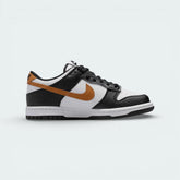 Side profile of the Nike Dunk Low Juniors in Black/White, showing the iconic leather overlays and the clean white midsole.