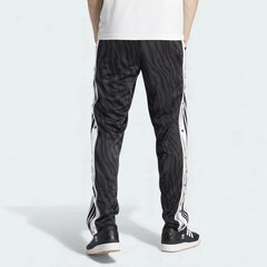 Adidas Adibreak Button Track Pants in black, back view showcasing the tapered leg and tonal animal print.