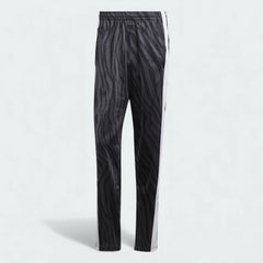 Adidas Adibreak Button Track Pants in black with a subtle animal print, front view showing the elastic drawcord waist and the full line of snap buttons down the side.
