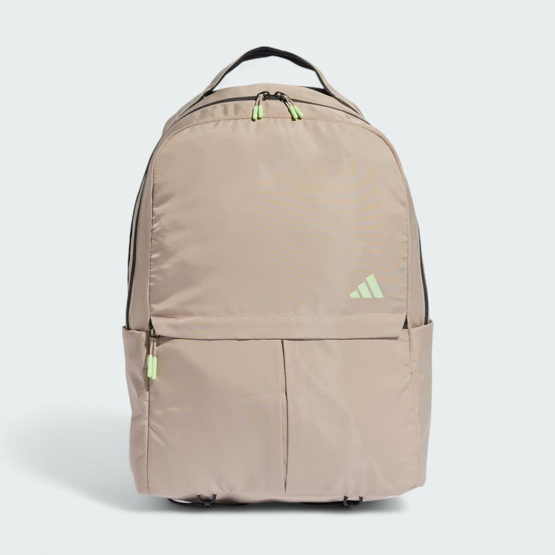 Adidas Women's Workout Backpack Yoga Bag in beige, front view showing main compartment zipper, front pocket, and external yoga mat strap.
