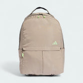 Adidas Women's Workout Backpack Yoga Bag in beige, front view showing main compartment zipper, front pocket, and external yoga mat strap.