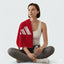 woman reflecting after a workout with the red towel over her shoulder