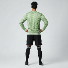 Man wearing the Adidas Handball Goalkeeper Long Sleeve Jersey in green, demonstrating its fit for athletic movement.