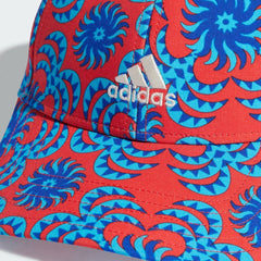 Close-up zoom on the fabric of the Adidas x Farm Rio cap, showing the intricate, colourful graphic print and the texture of the recycled polyester material.