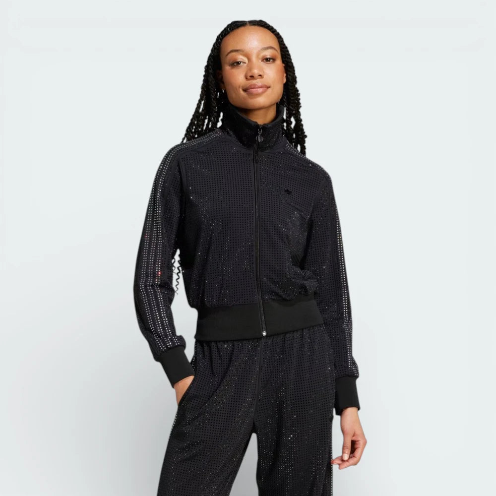 Front profile of the Preloved Ruby track jacket, showing the slim-fit silhouette and the iconic contrast 3-Stripes running down the sleeves.