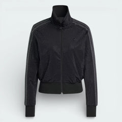 Close-up of the upper chest, focusing on the high-quality embroidery of the Trefoil logo and the sturdy metallic zipper pull.